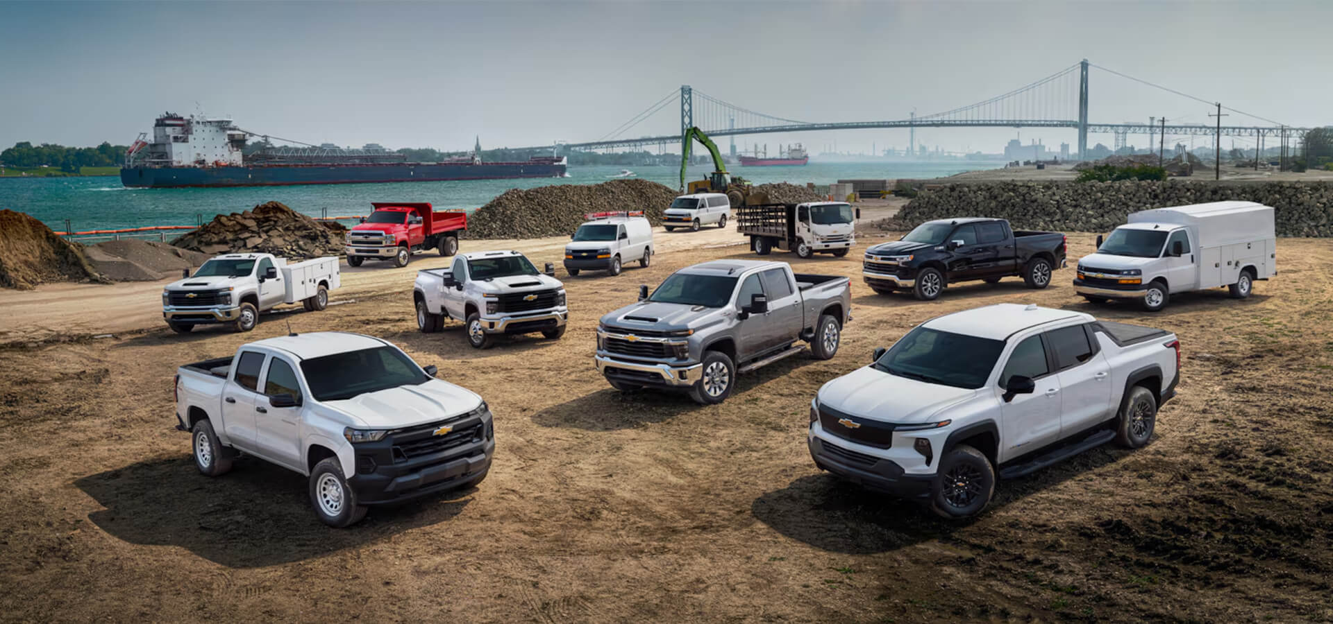 Lineup of Chevy trucks with mountains in the background