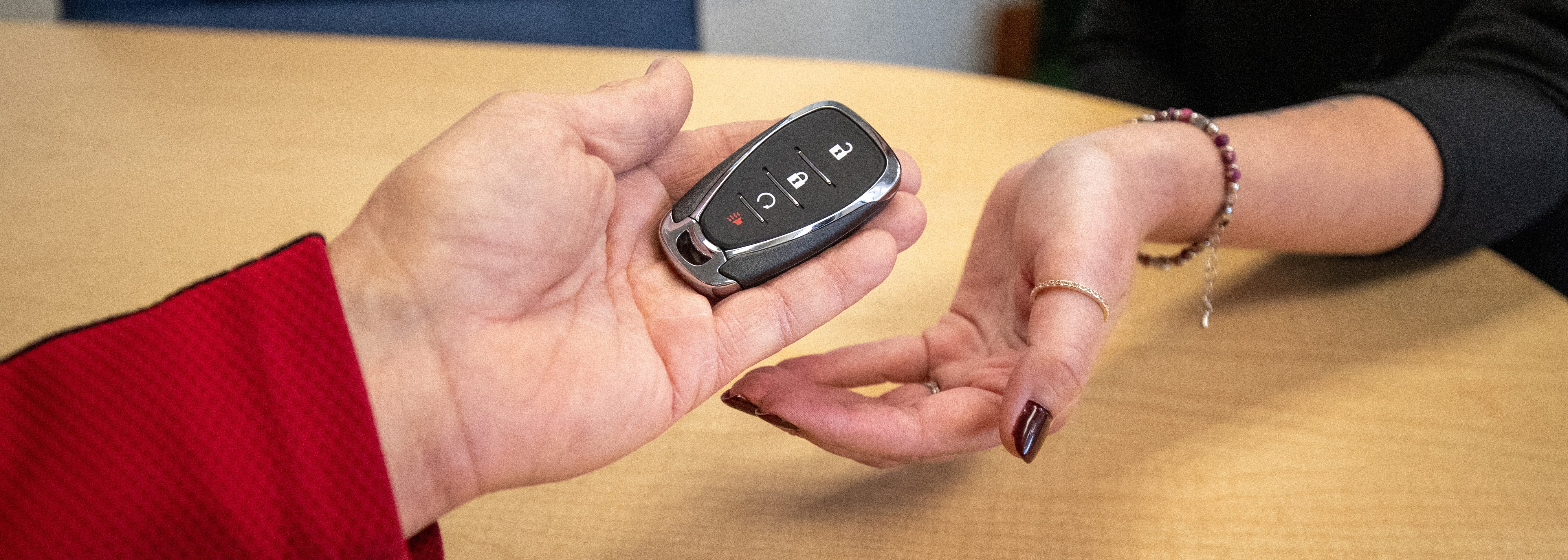 Dealership salesperson agreeing the sale with a customer.